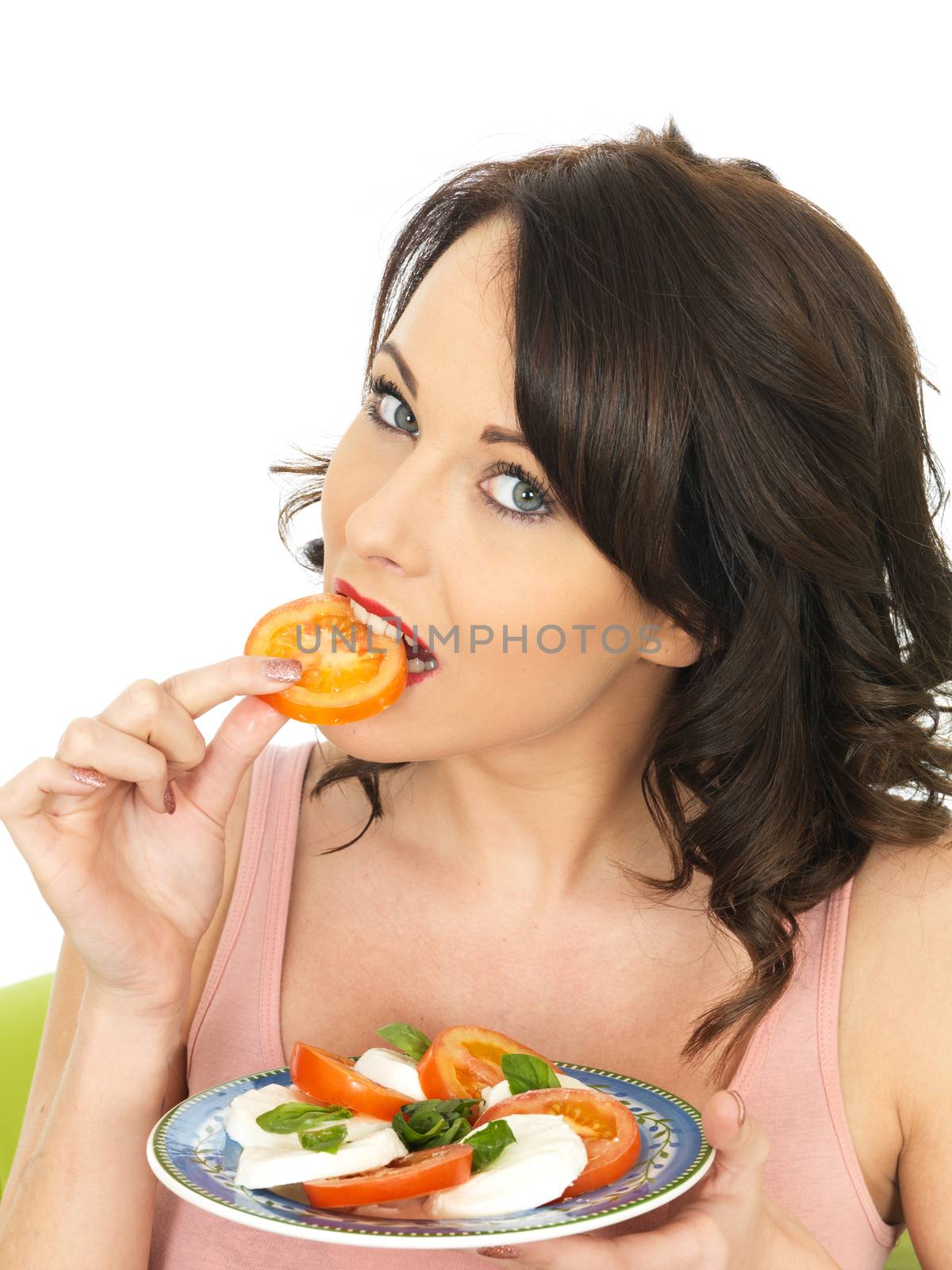 Attractive Young Woman  Eating A Slice of Tomato by Whiteboxmedia