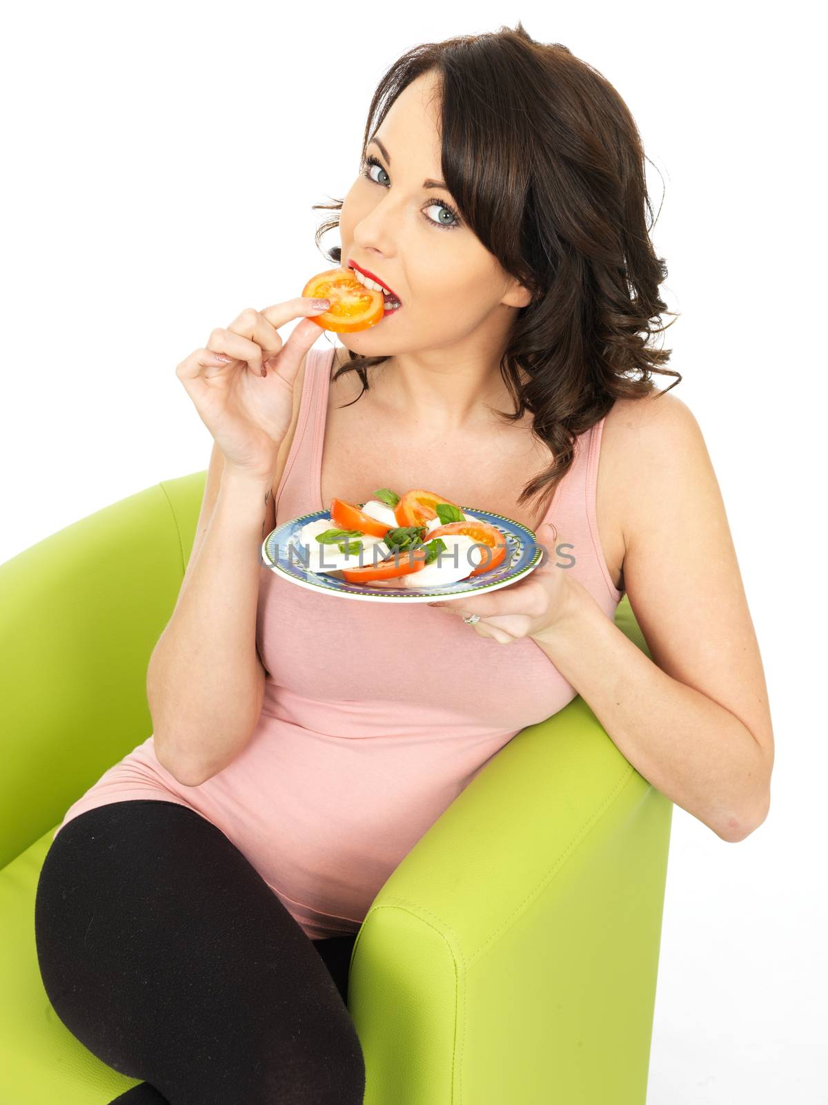 Young Healthy Woman Eating a Mozzarella Cheese and Tomato Salad