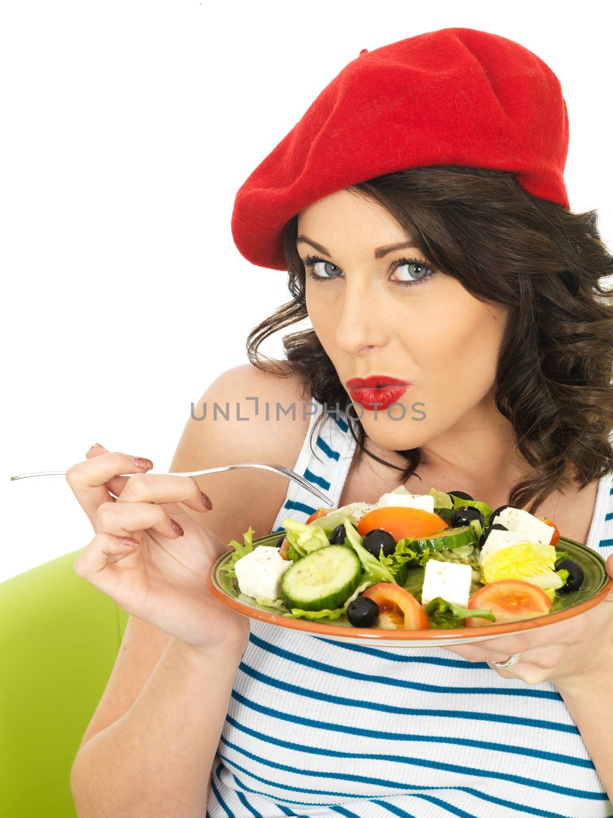 Young Woman Eating a Fresh Crispy Greek Salad by Whiteboxmedia