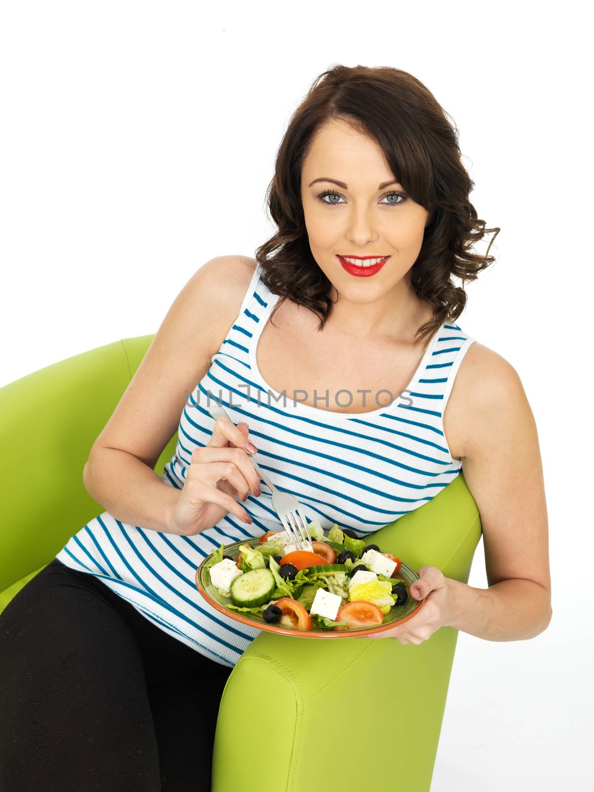 Young Woman Eating a Fresh Crispy Greek Salad by Whiteboxmedia