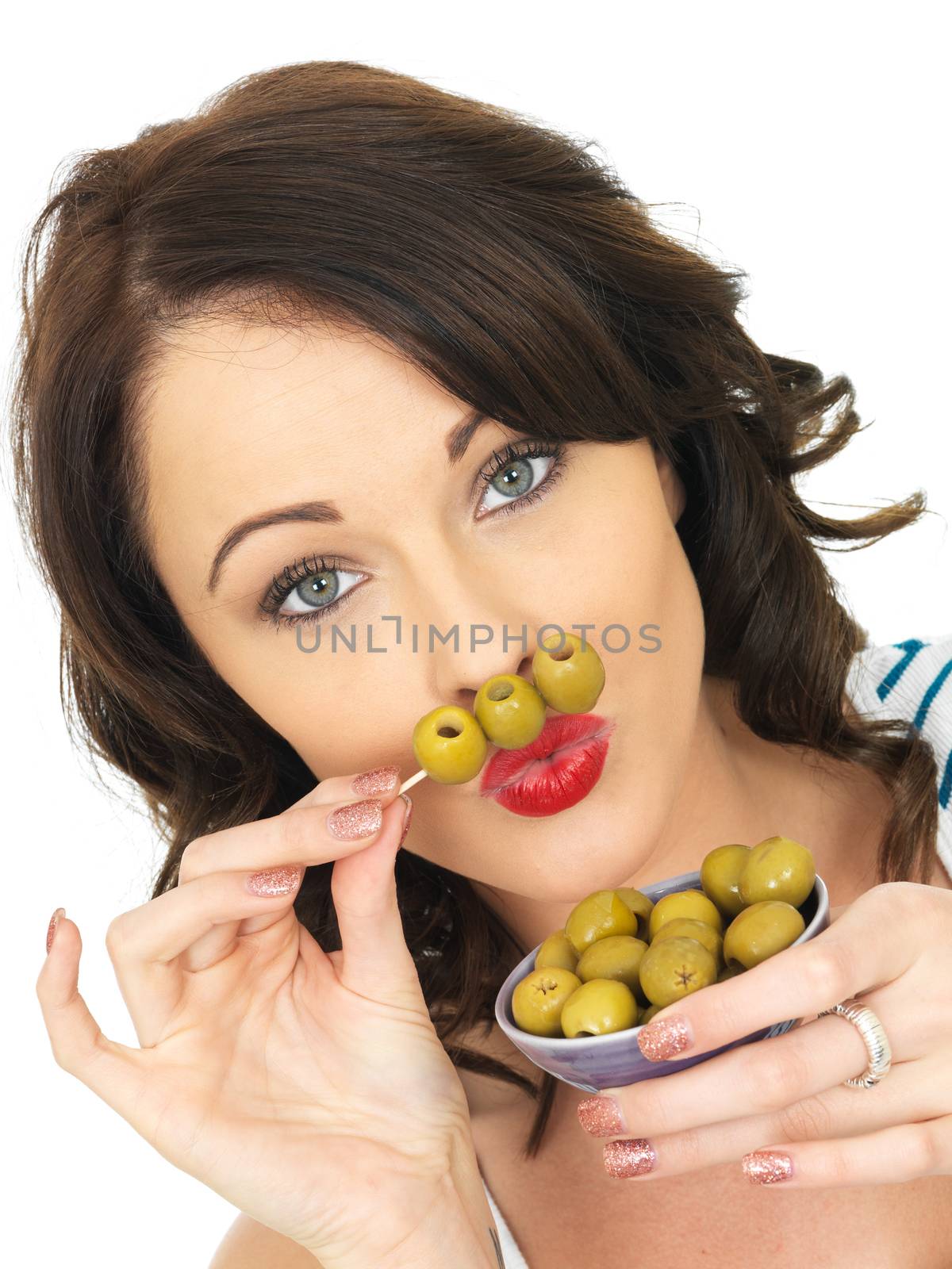 Young Woman Eating Green Olives by Whiteboxmedia