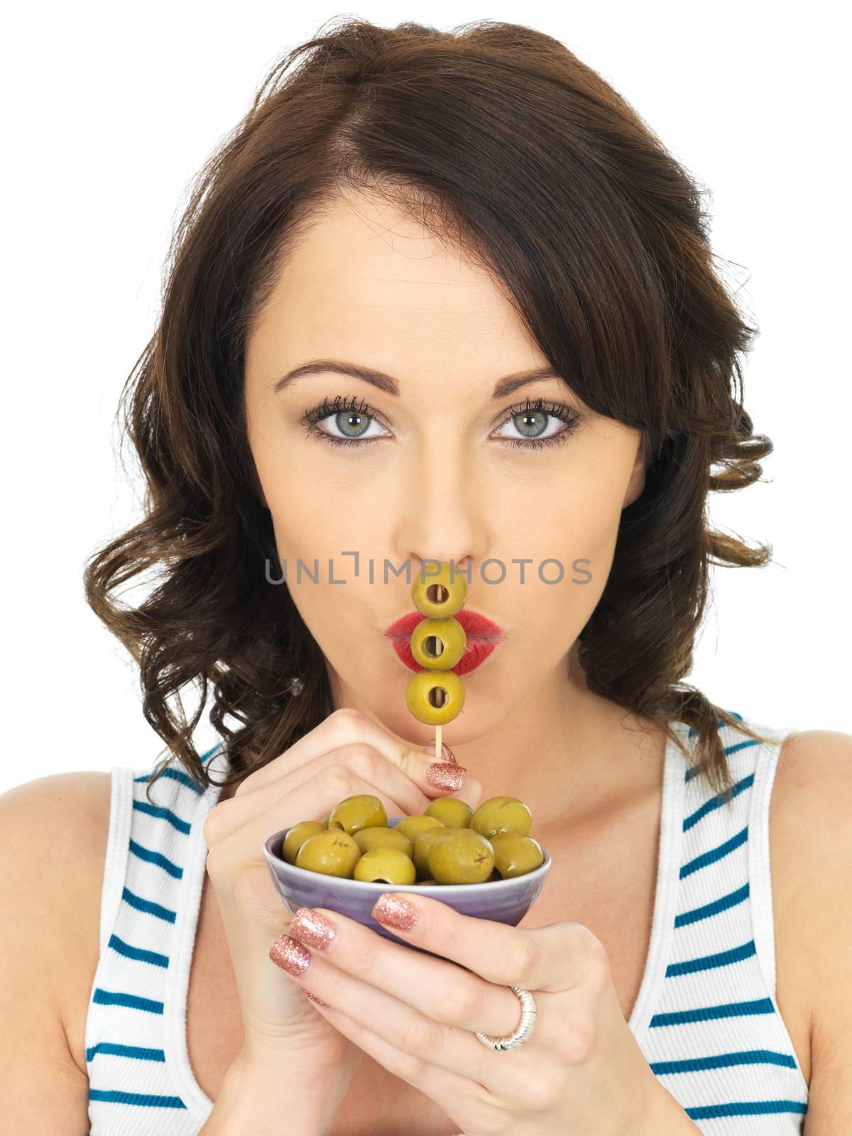 Young Woman Eating Green Olives by Whiteboxmedia