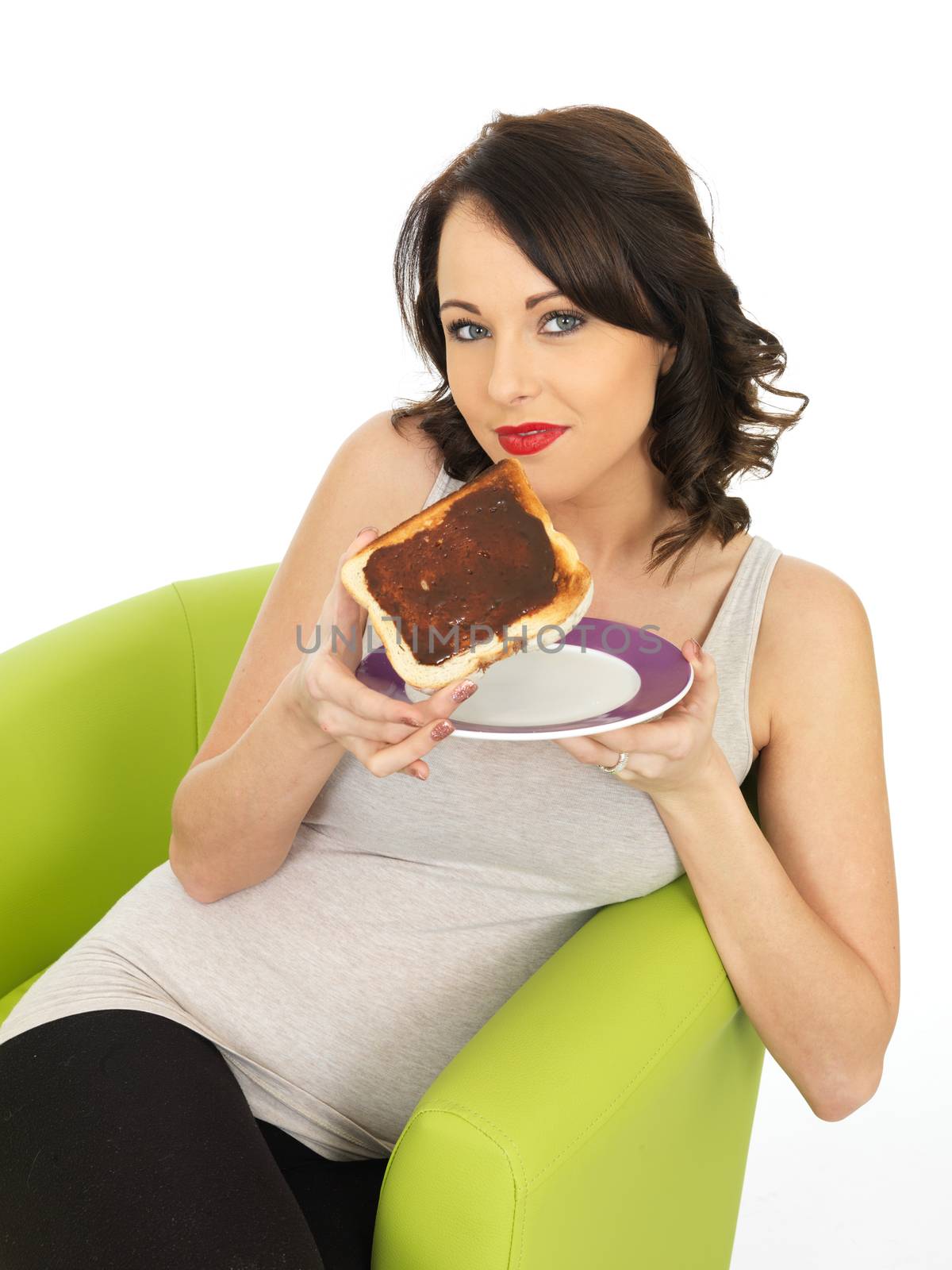 Young Woman Holding Toast Spread with Yeast Extract by Whiteboxmedia