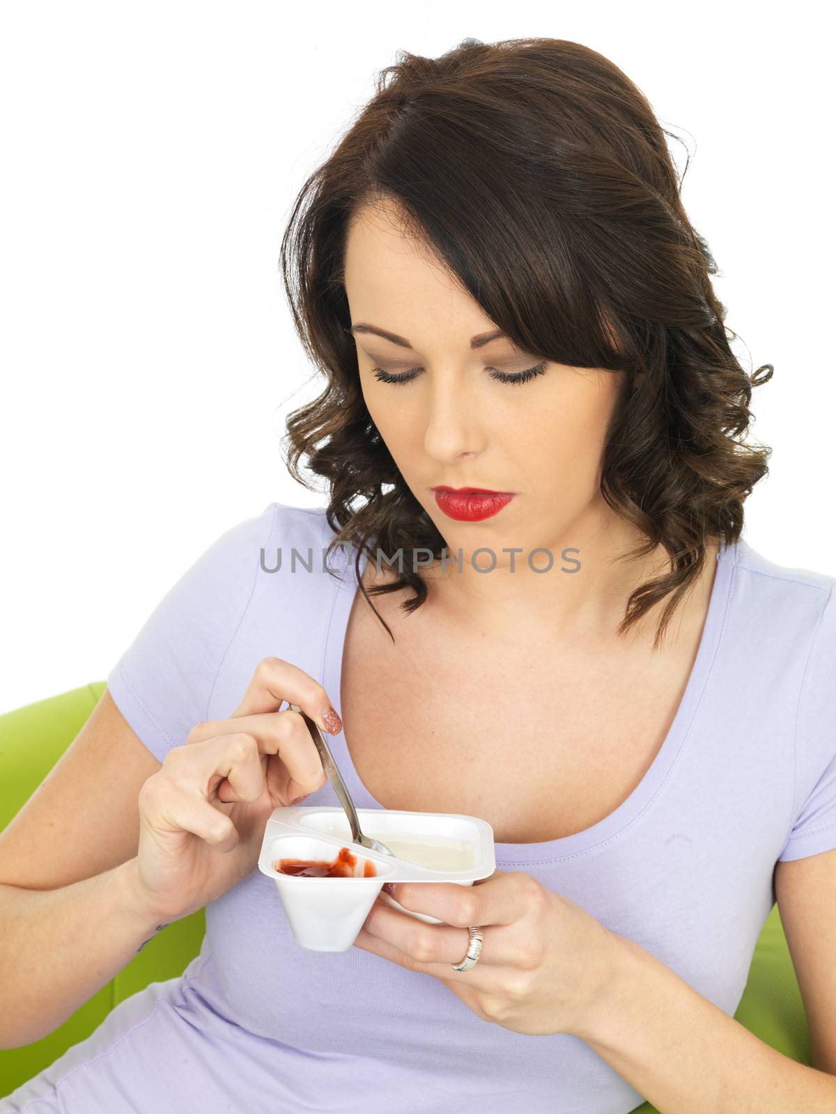 Young Woman Eating a Yogurt by Whiteboxmedia