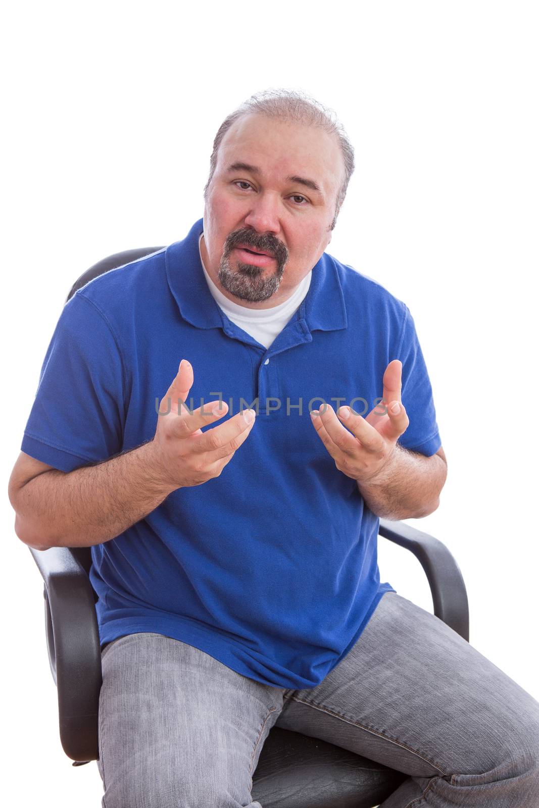 Close up Bearded Middle Age Guy Sitting on a Chair, Explaining Something While Looking at the Camera. Isolated on White Background.