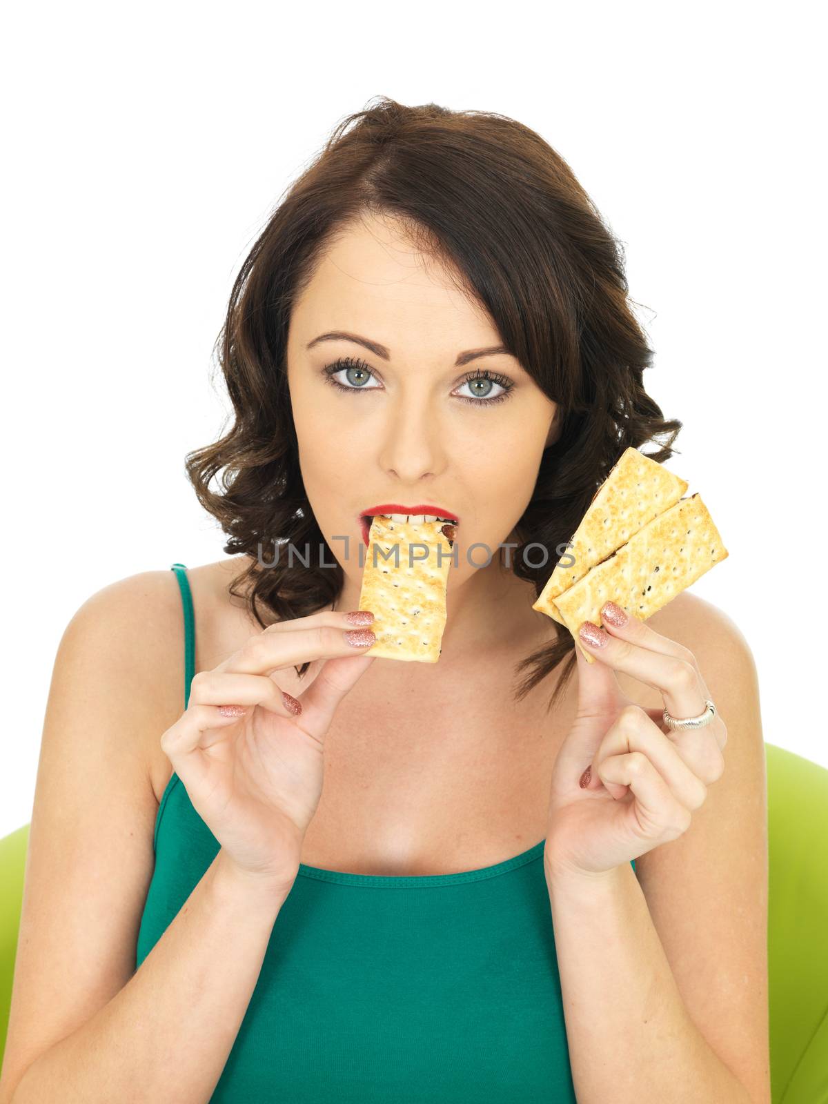 Young Woman Eating Crispy Thin Crackers by Whiteboxmedia