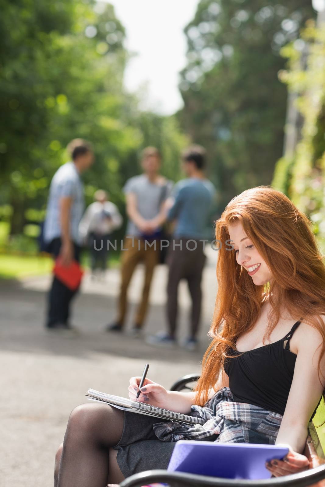 Pretty student studying outside on campus at the university