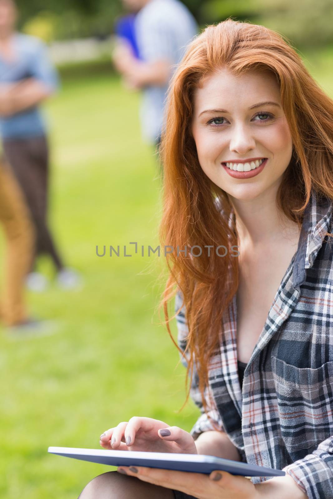 Pretty student studying outside on campus by Wavebreakmedia