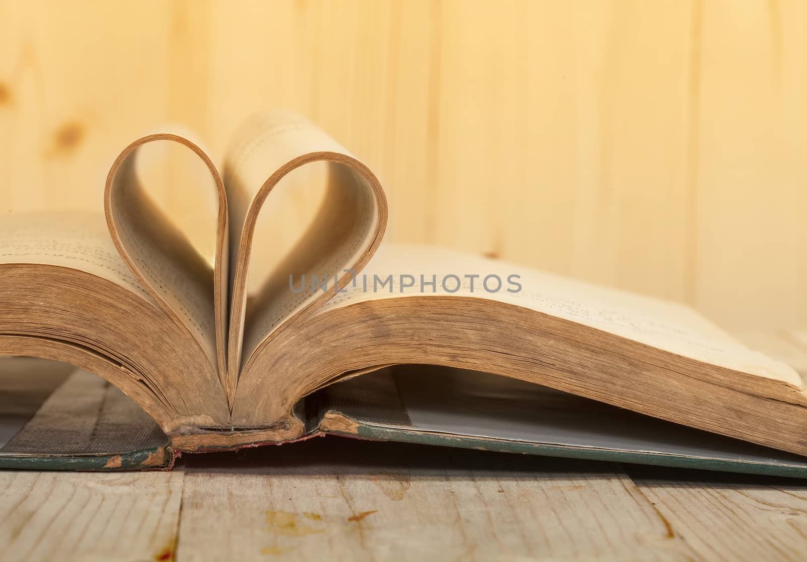 open old book rolled in heart shape
