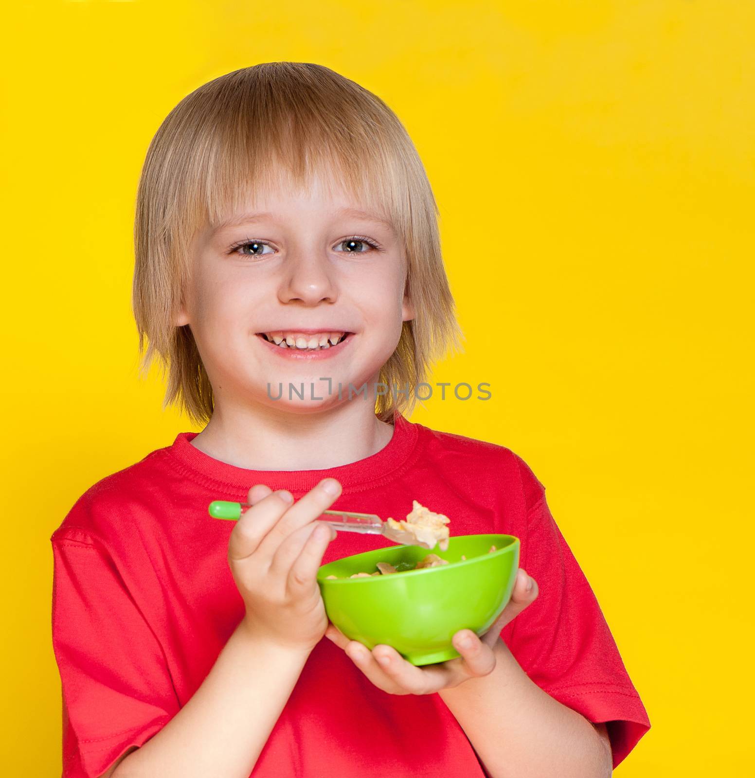 Blond boy kid child eating corn flakes cereal by Anpet2000