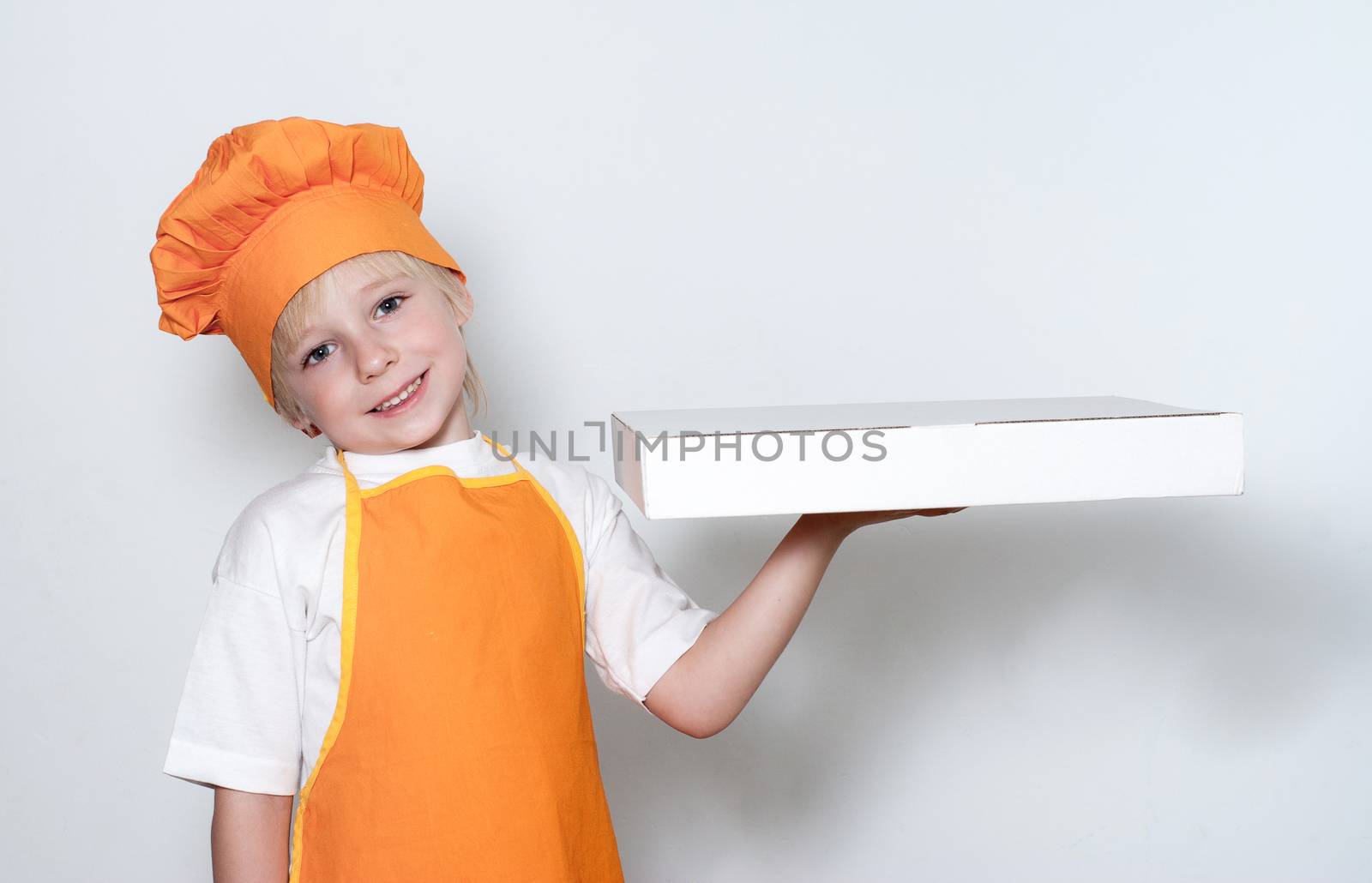 Portrait of the little cook with a box for pizza