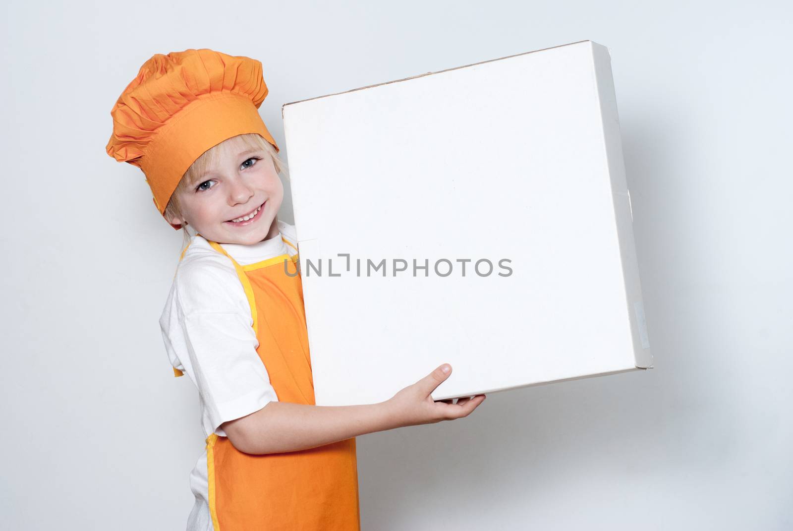 Portrait of the little cook with a box for pizza