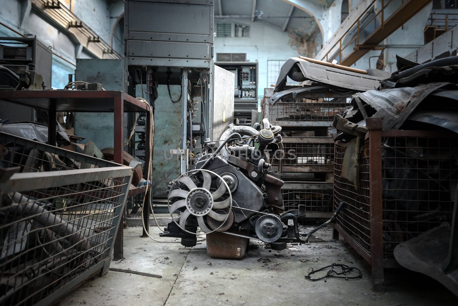The image of an used engine in empty factory