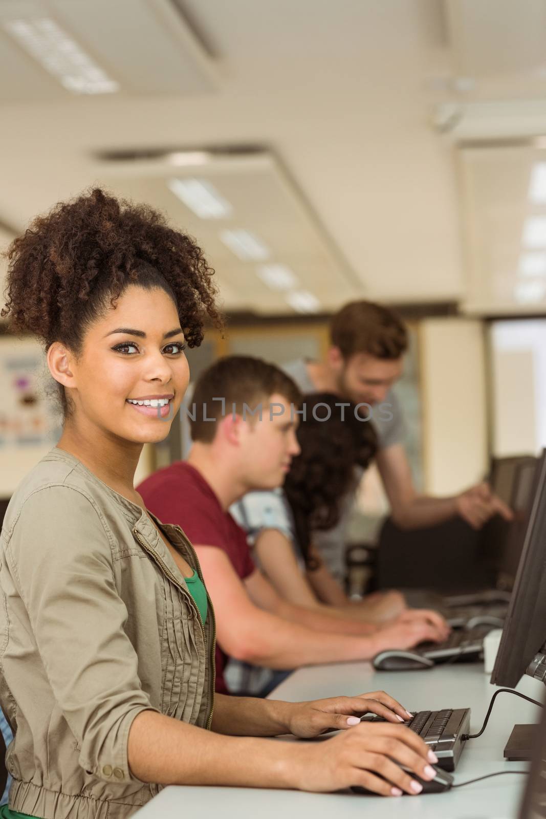 Classmates working in the computer room by Wavebreakmedia