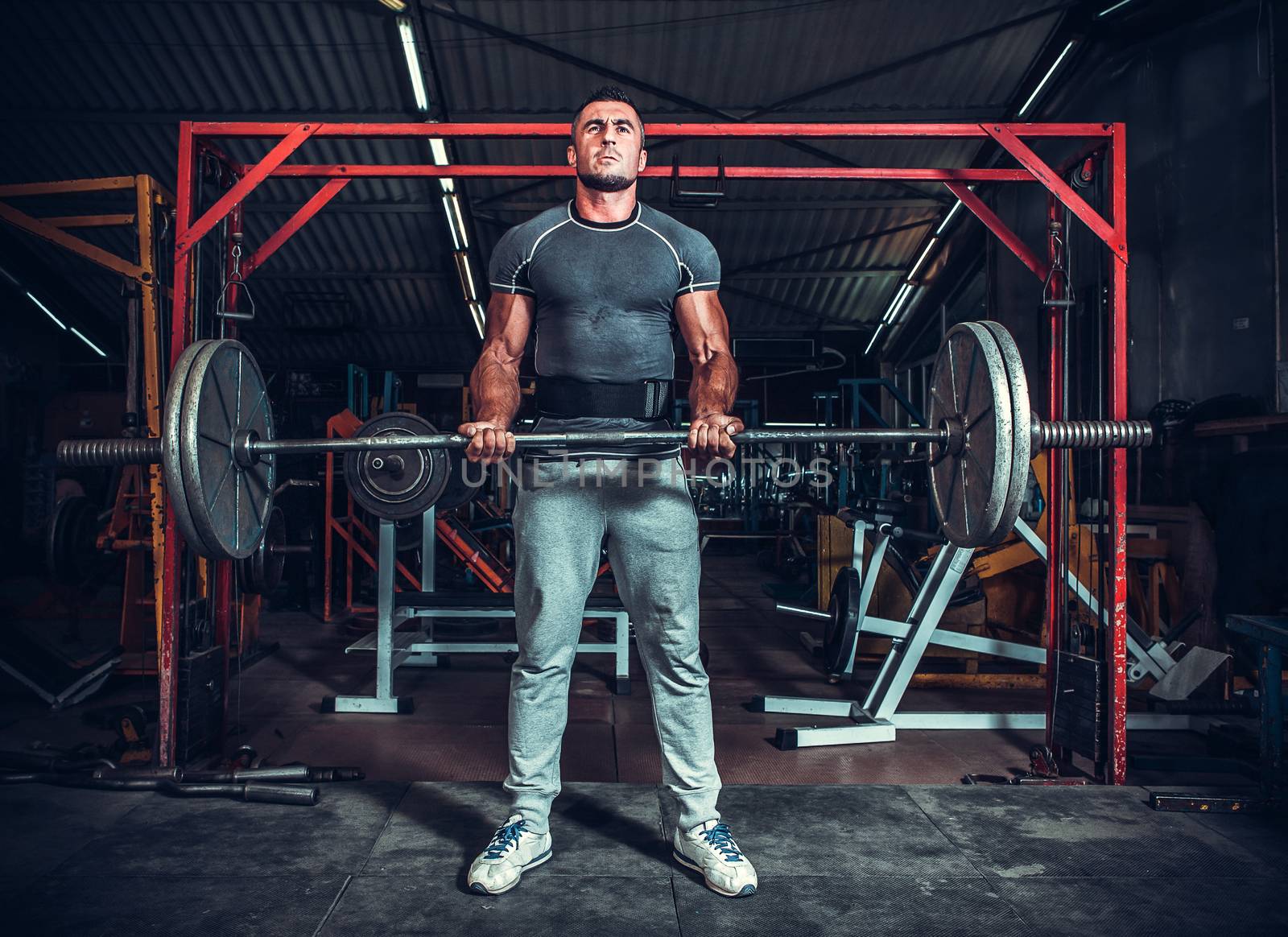 Powerlifter with strong arms lifting weights