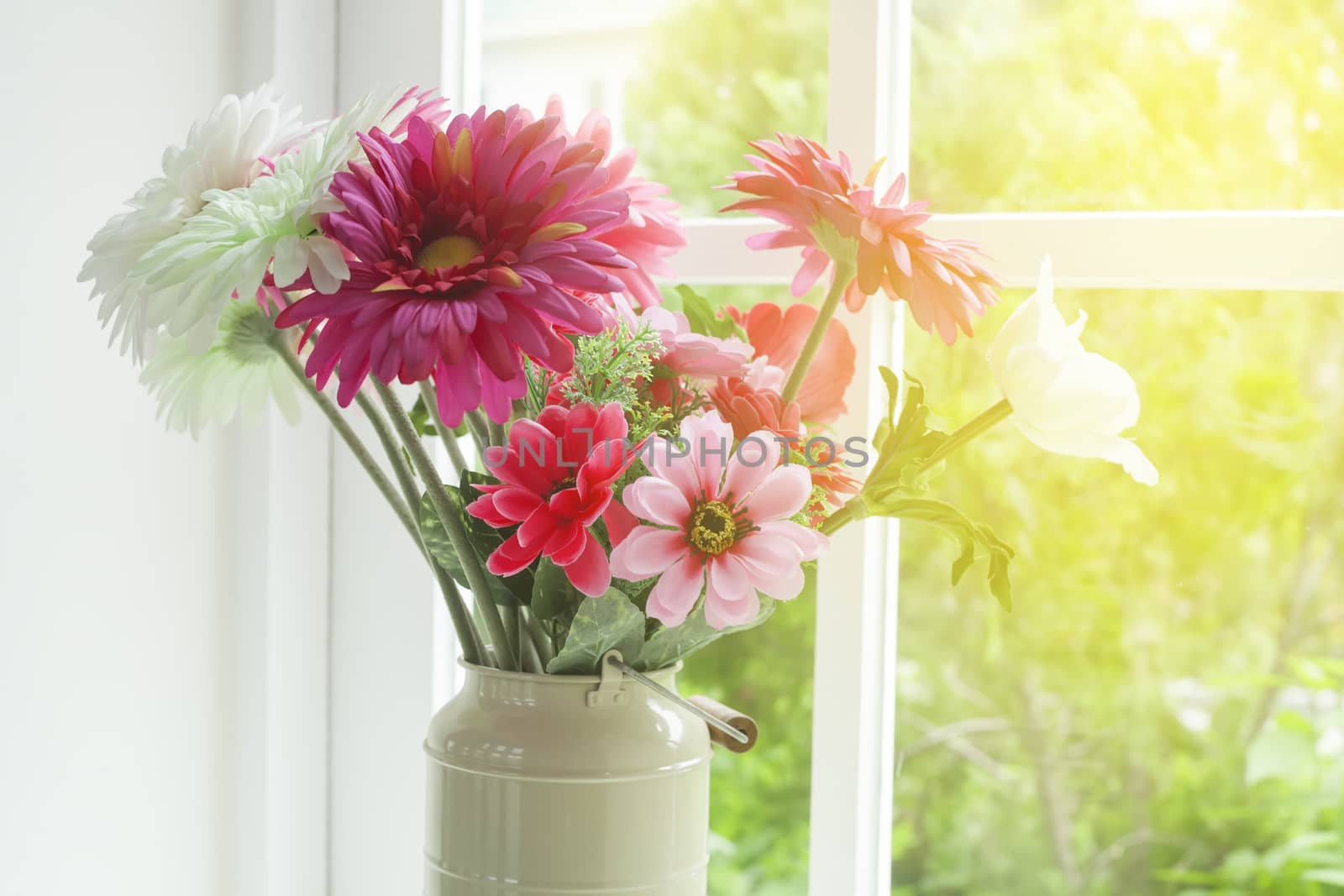Flowers in glass vase near the window