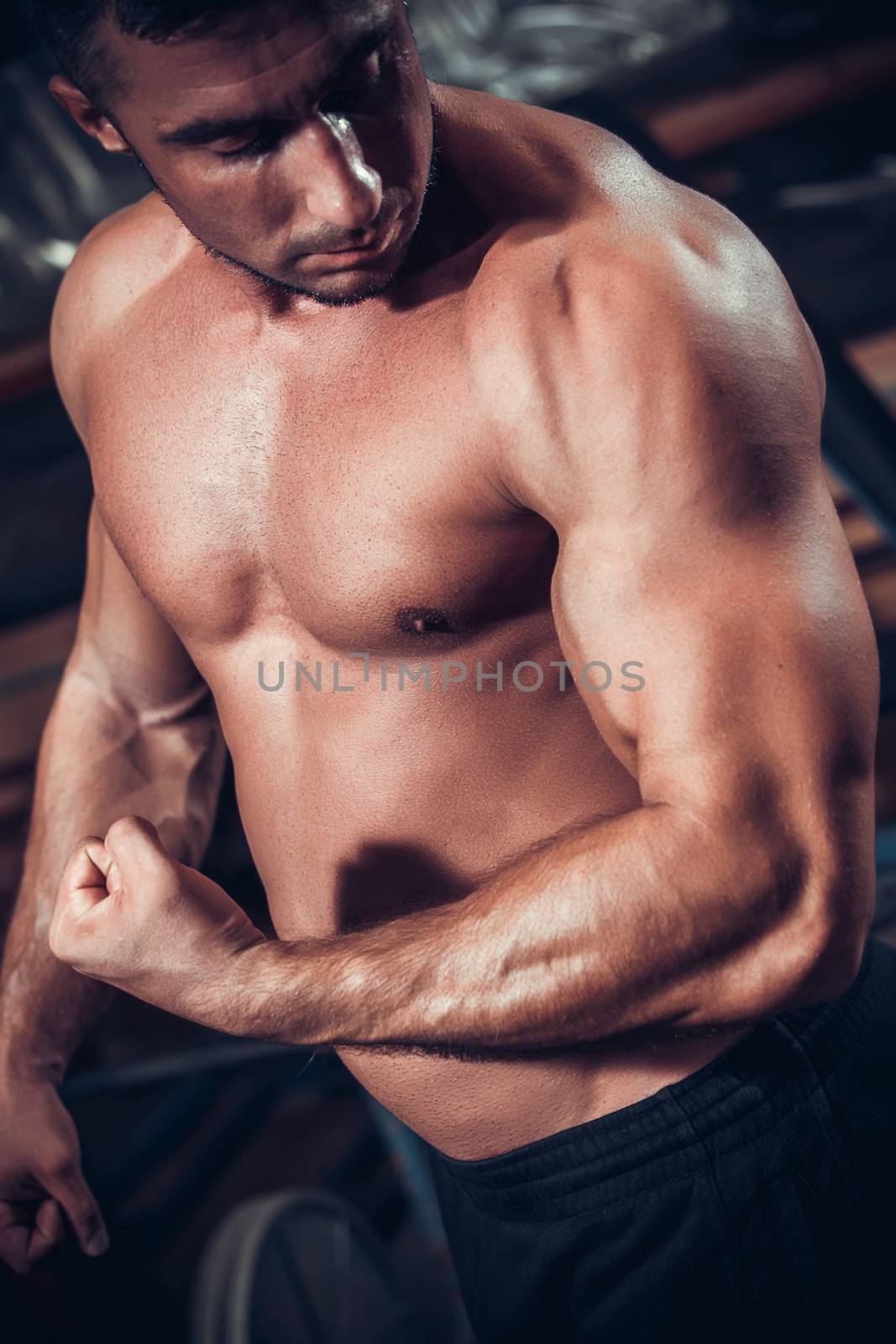 Male bodybuilder flexing his muscles