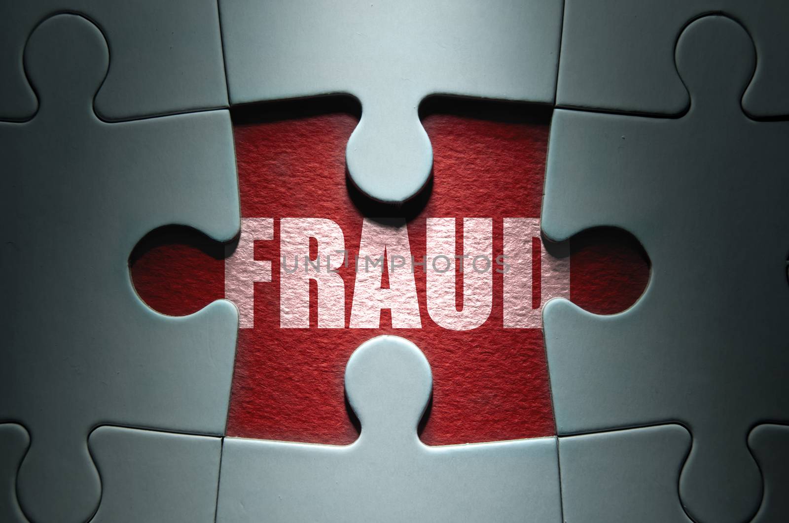 Missing piece from a jigsaw puzzle revealing the word fraud