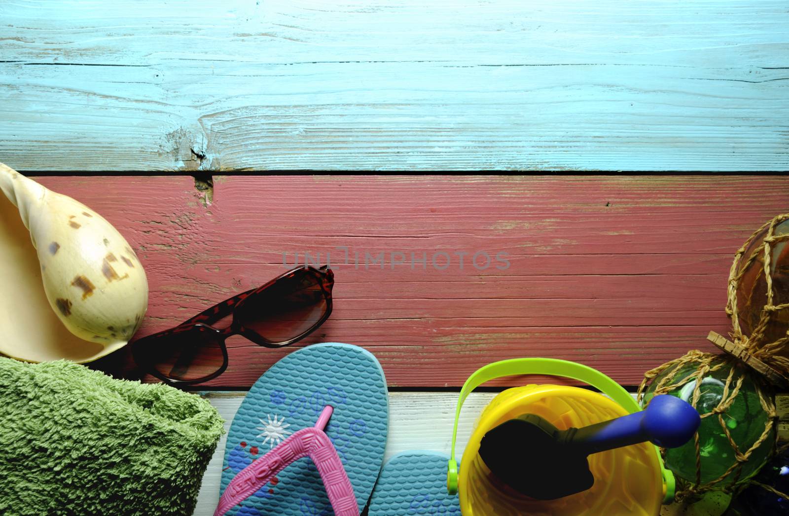 Summer beach hut objects including sunglasses, sea shell and towel