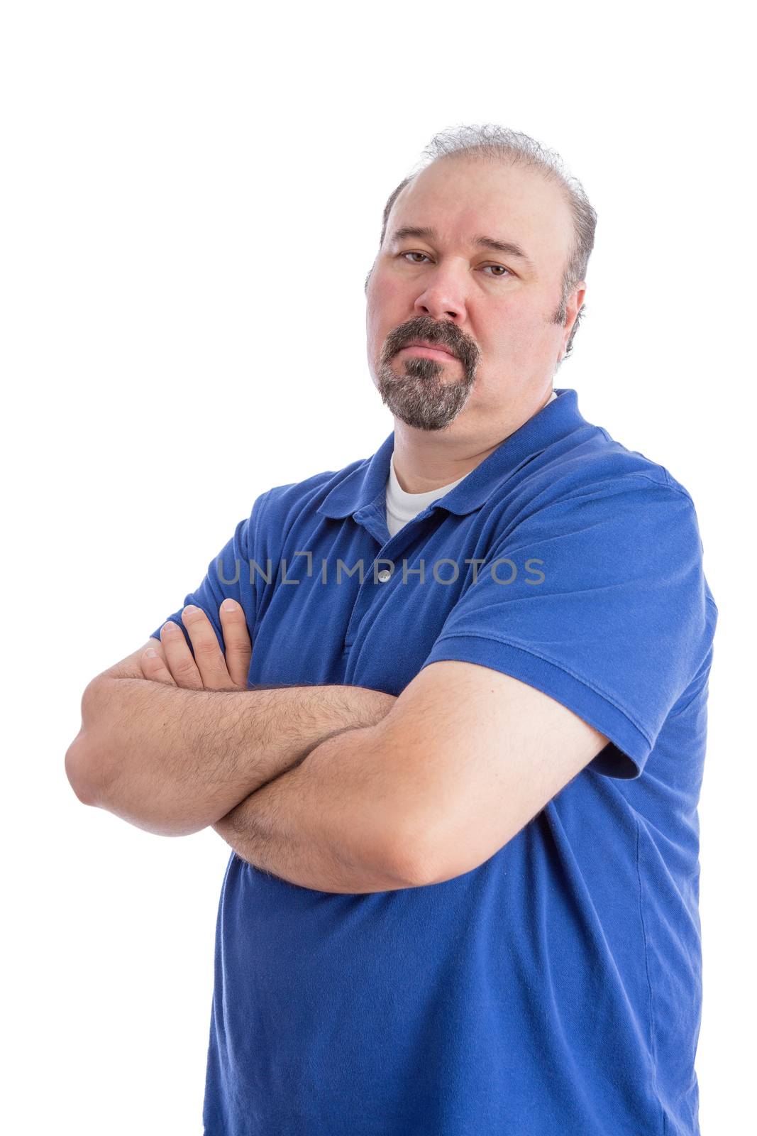 Portrait of a Serious Bearded Man in Blue Polo Shirt, Crossing his Arms and Looking at the Camera in an Aggressive Look. Isolated on White Background.