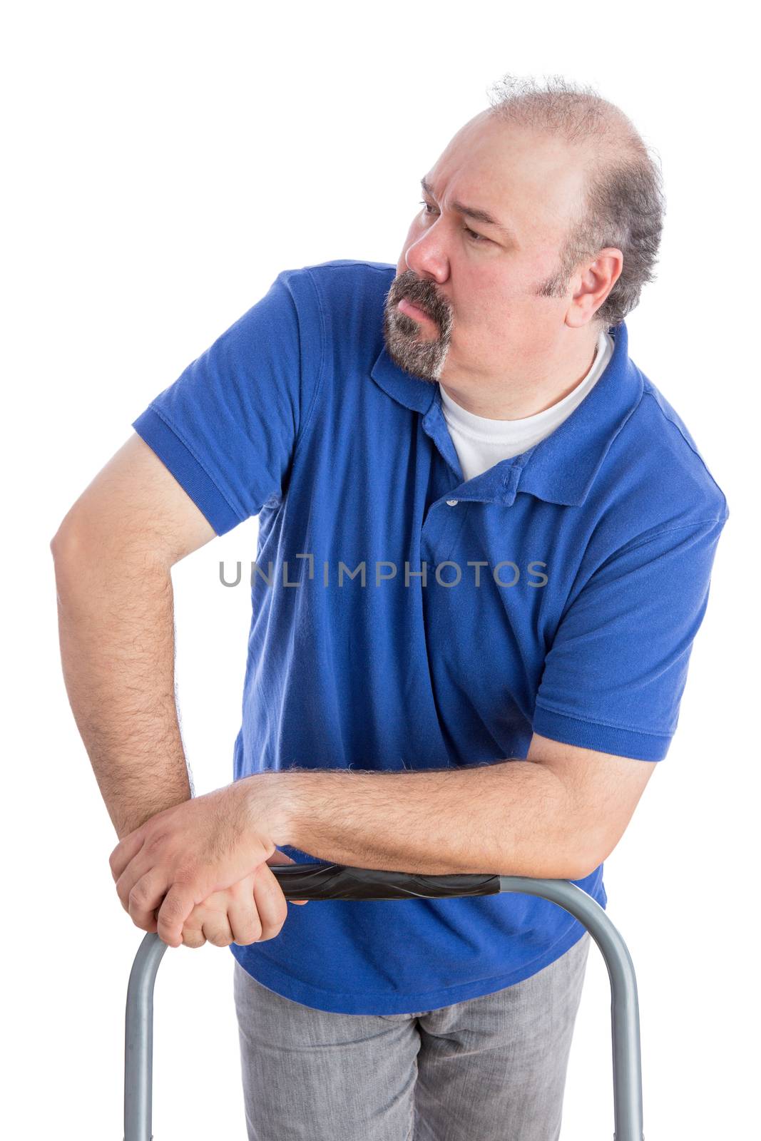 Serious Adult Man in Blue Shirt Leaning Against the Chair While Looking to the Left. Isolated on White.