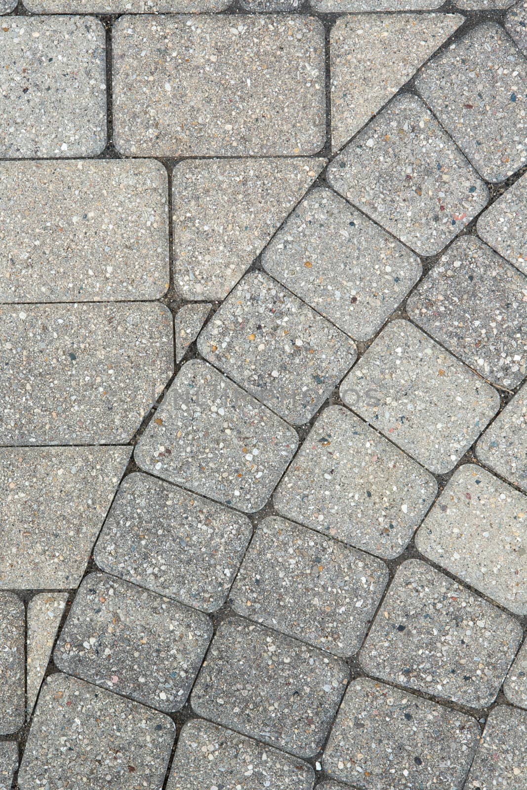 Grey brick paving background pattern and texture a portion of the edge of a circular design with the flooring