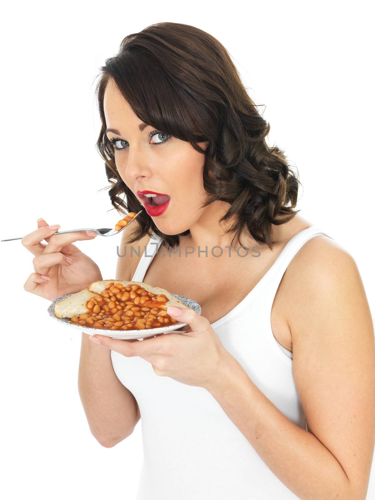 Young Woman Eating Baked Beans on Toast by Whiteboxmedia