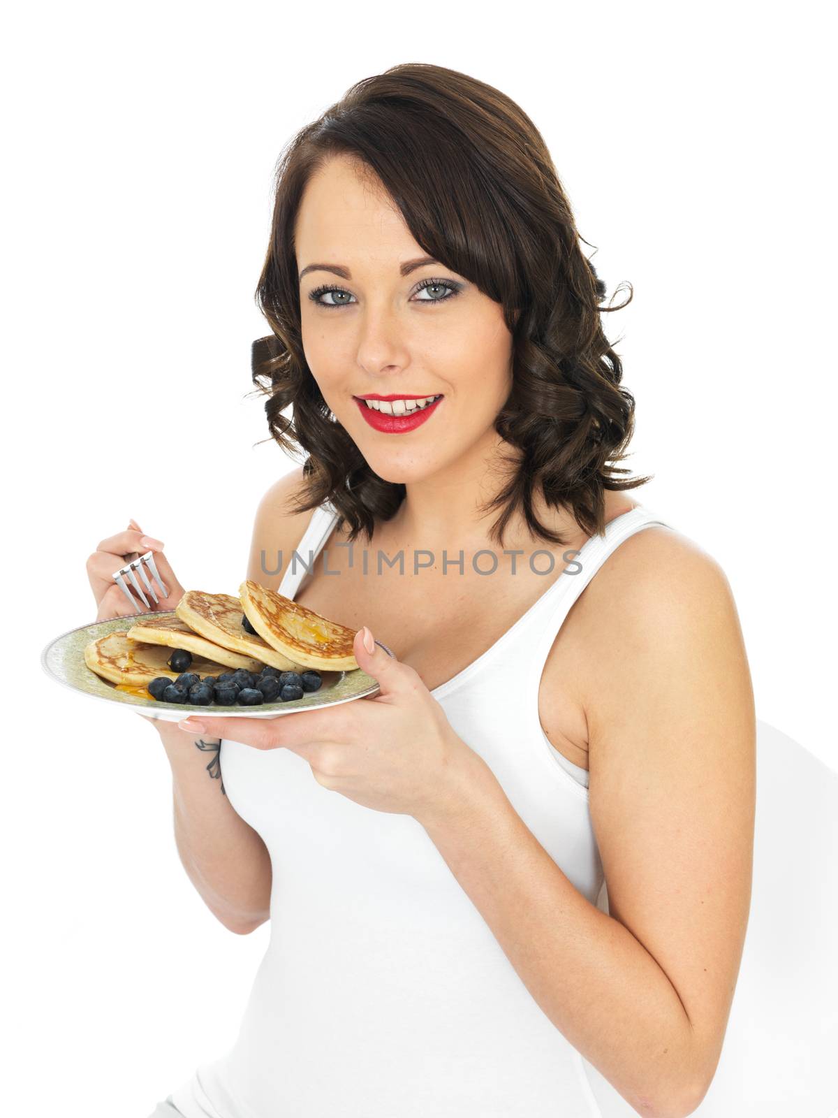 Young Woman Eating Pancakes with Blueberries by Whiteboxmedia