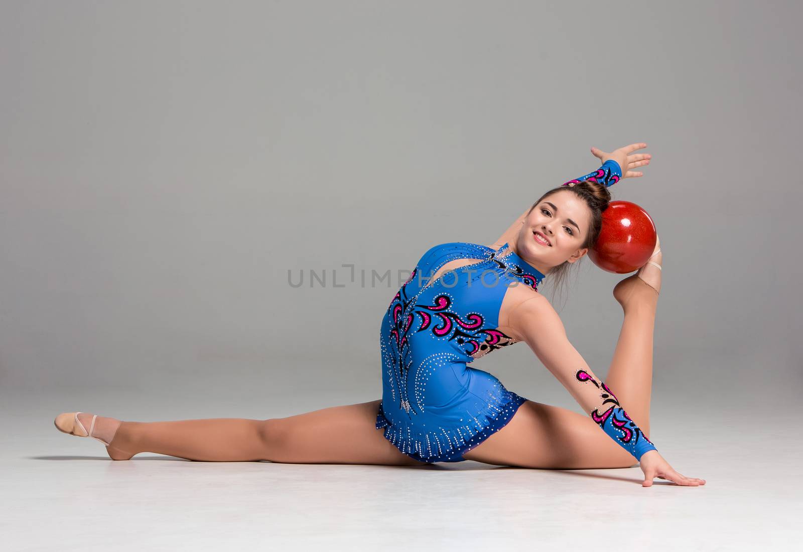 teenager doing gymnastics exercises with red gymnastic ball by master1305