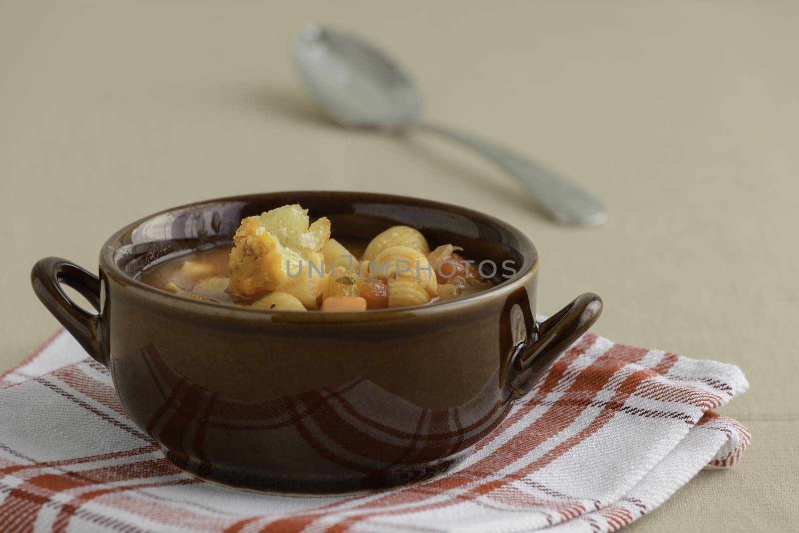 Bowl of rustic homemade minestrone soup with crouton.