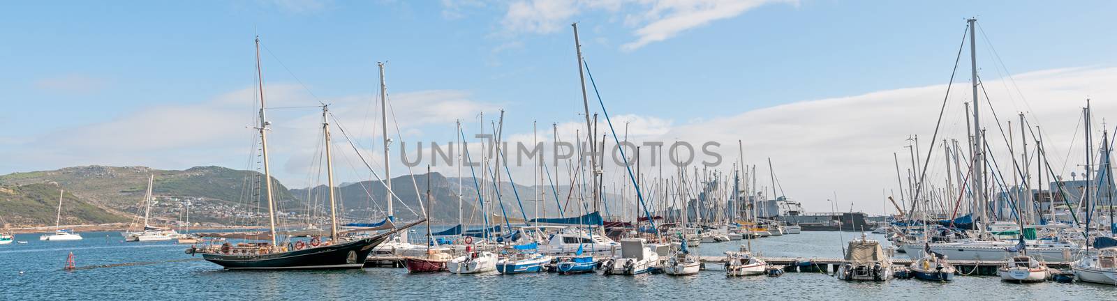 CAPE TOWN, SOUTH AFRICA - DECEMBER 12, 2014:  Simons Town harbor with two South African Navy Valour class frigates and S99, the SAS Assegaai, a Daphne class submarine, now a museum item, in the back