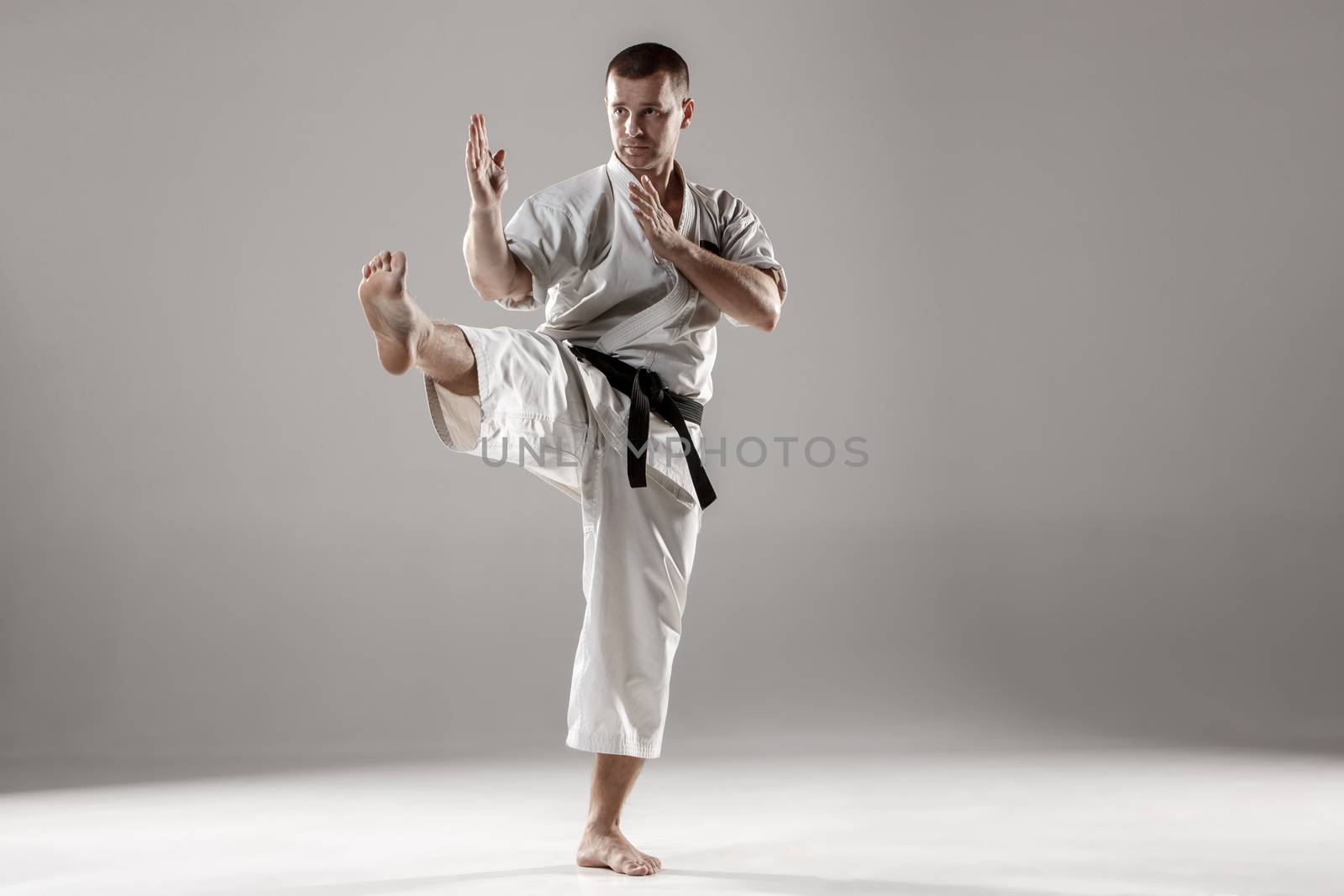 Man in white kimono training karate by master1305