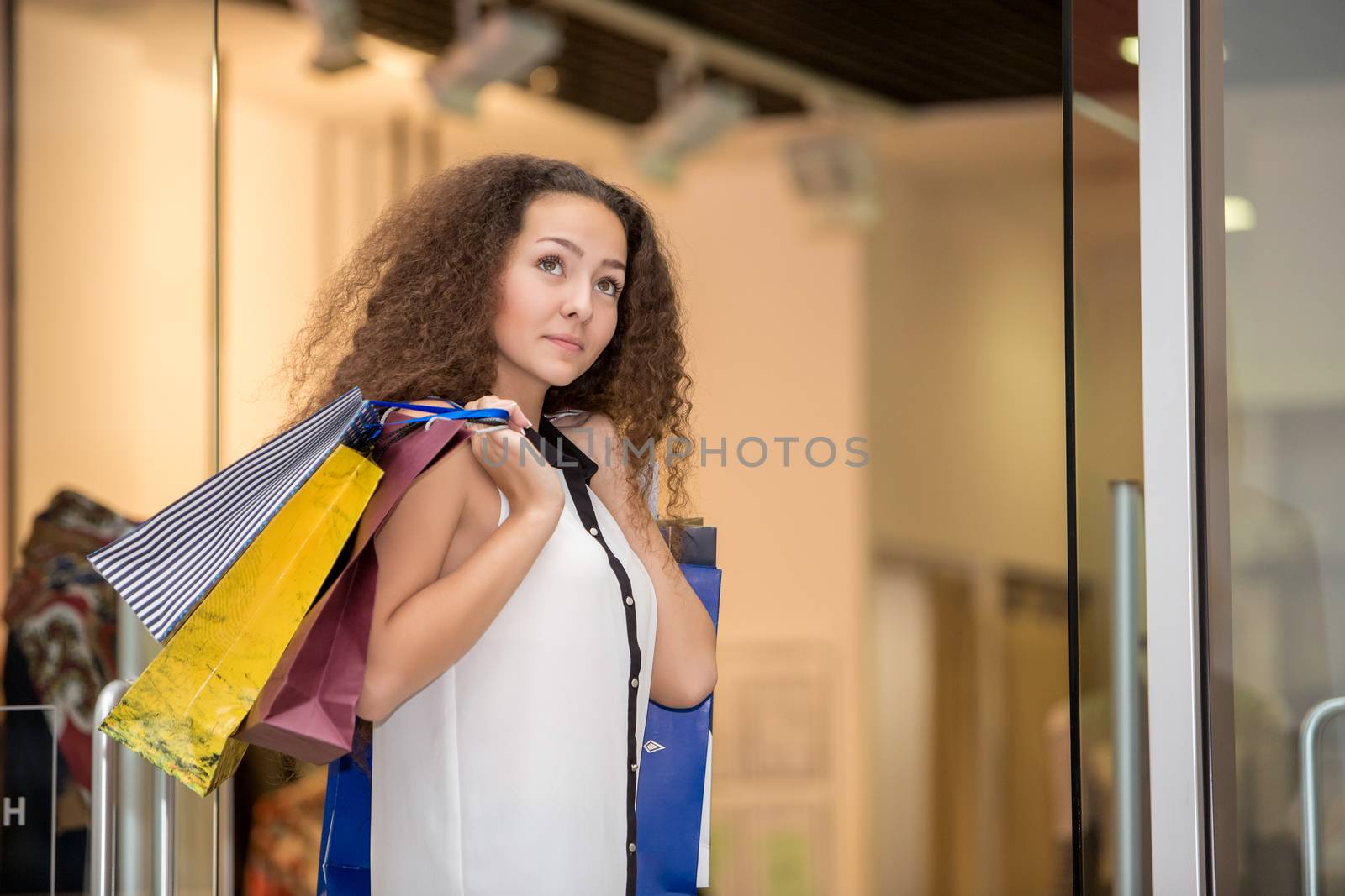 beautiful young woman with a shopping bags in the mall by master1305