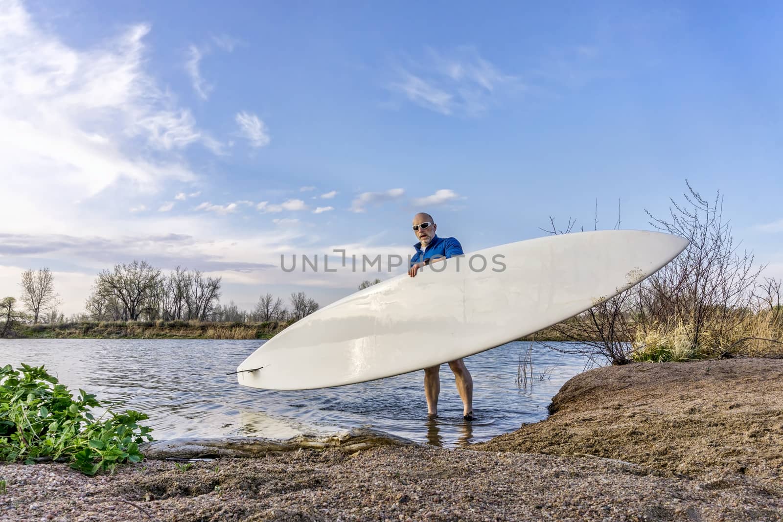 launching stand up paddleboard by PixelsAway