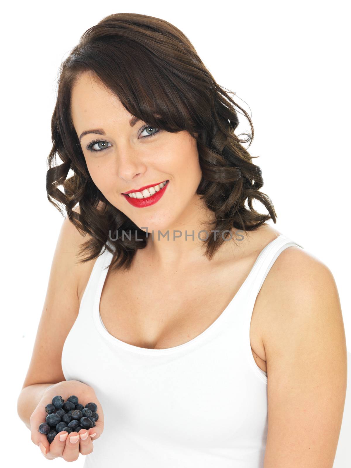 Healthy Young Woman Holding a Handful of Blueberries