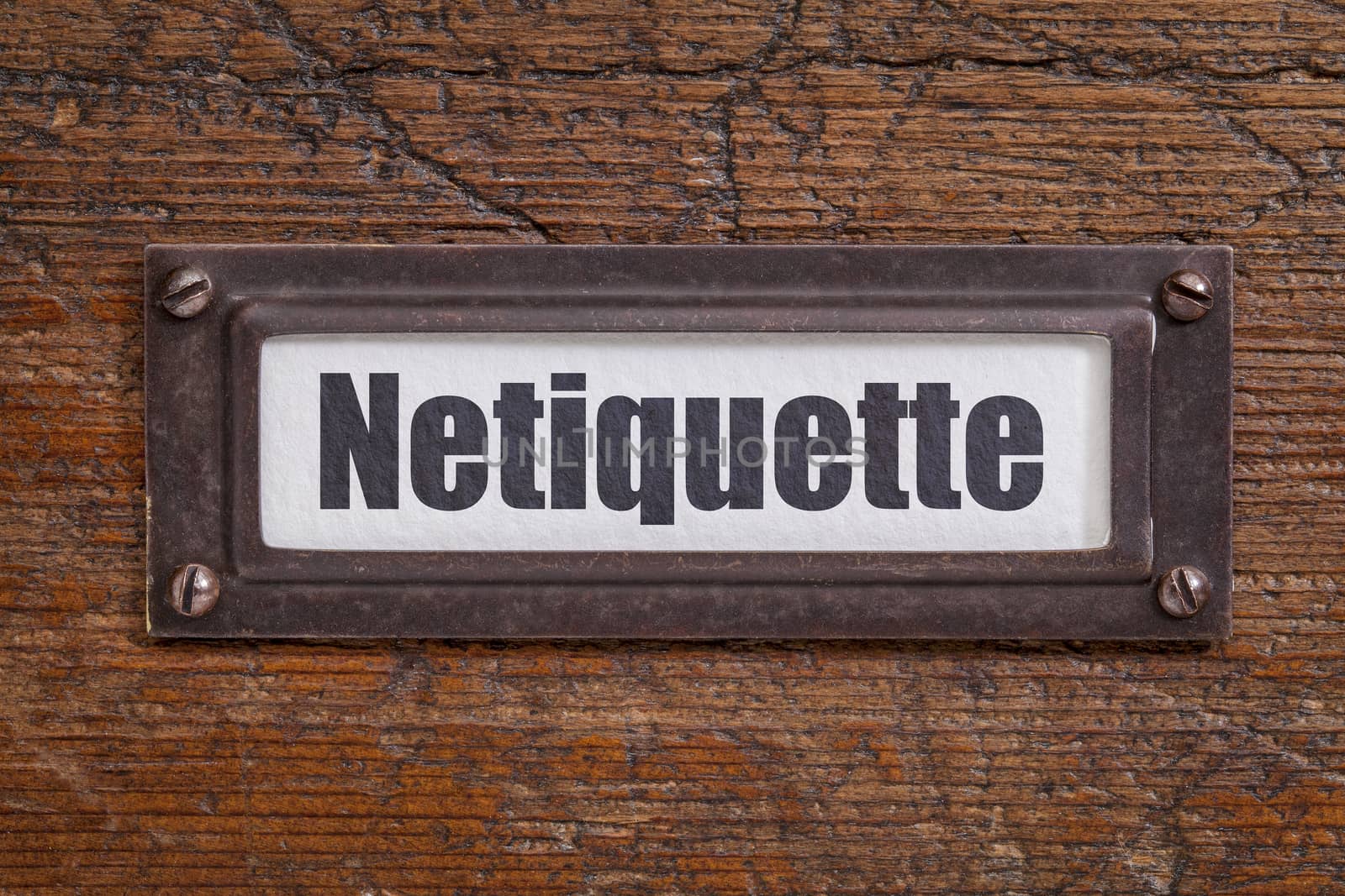 netiqutte (internet etiquette)  - file cabinet label, bronze holder against grunge and scratched wood