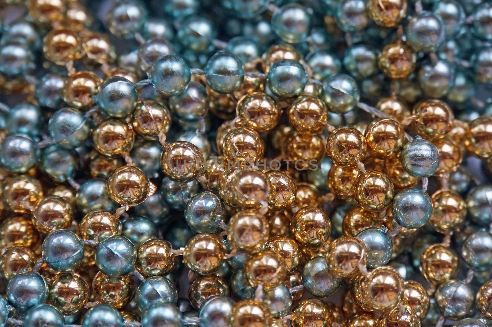 Background of golden and blue glass shiny large beads                               