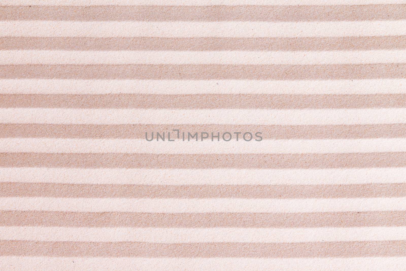 Creative sand background with abstract pattern of alternating lines of beige and golden sand in a repeat full frame pattern suitable as a design template and copyspace