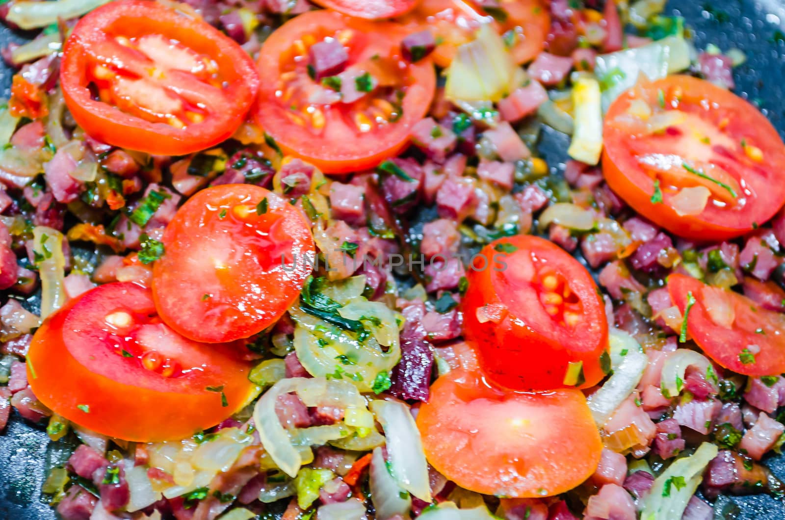 Tomatoes with bacon, onions and spices. Basis for a tomato sauce.