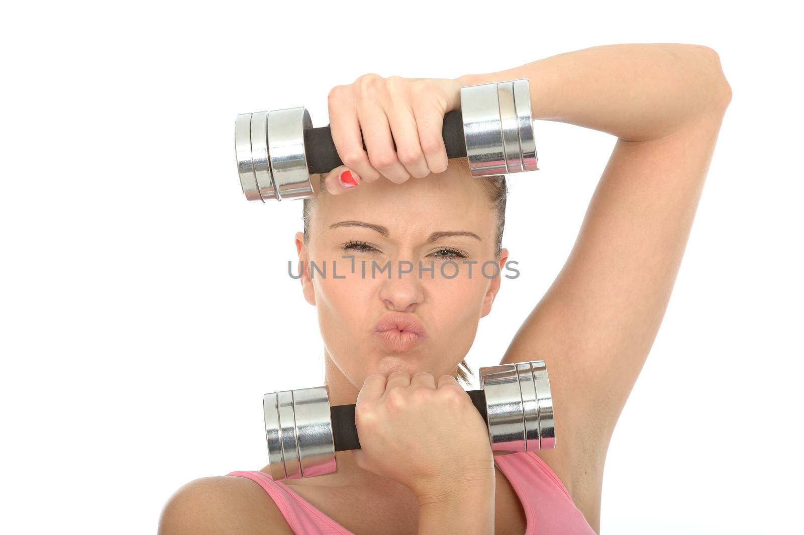 Healthy Young Woman Stressing While Training With Weights Looking at Camera Pulling Faces