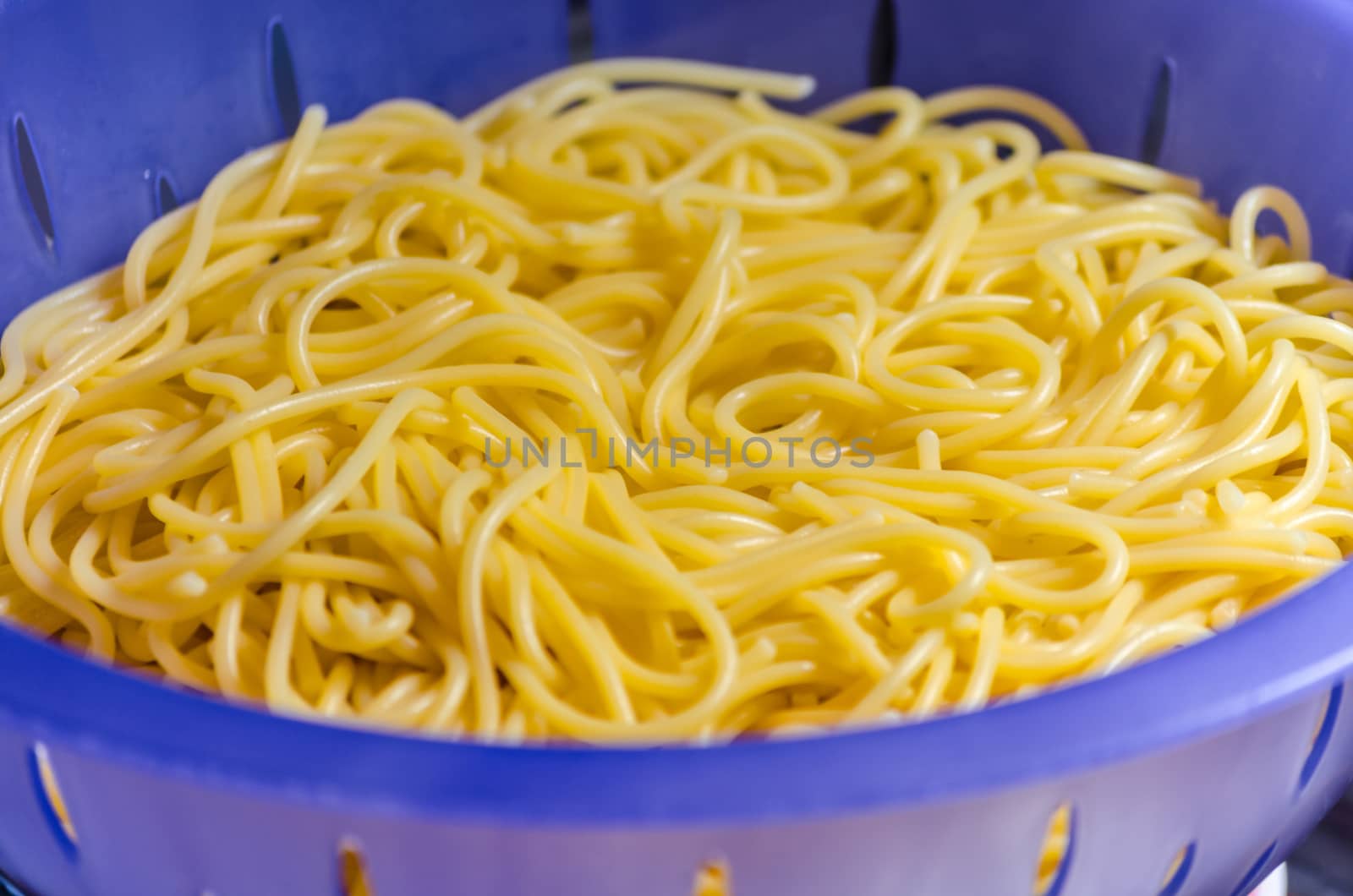 Noodles in a colander under cold water after the scare.
