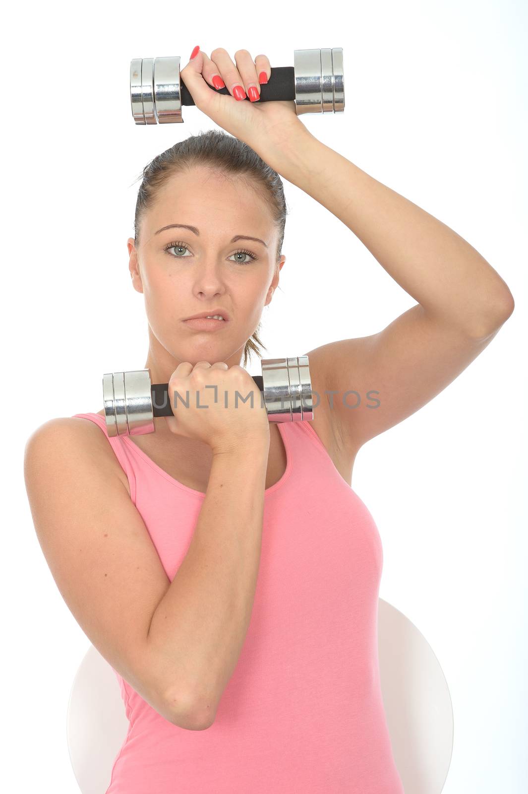 Healthy Young Woman Stressing While Training With Weights by Whiteboxmedia