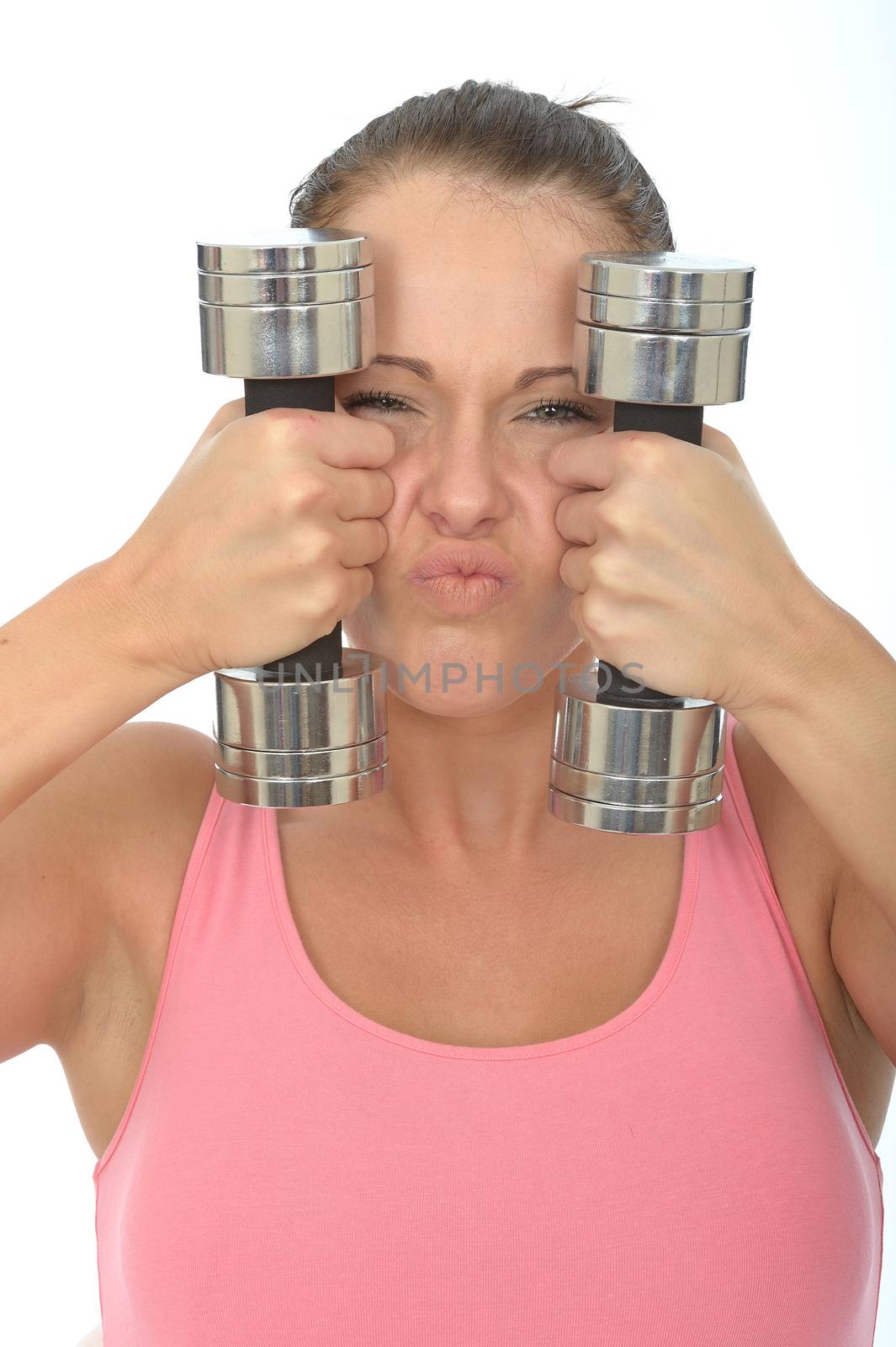 Healthy Young Woman Stressing While Training With Weights by Whiteboxmedia