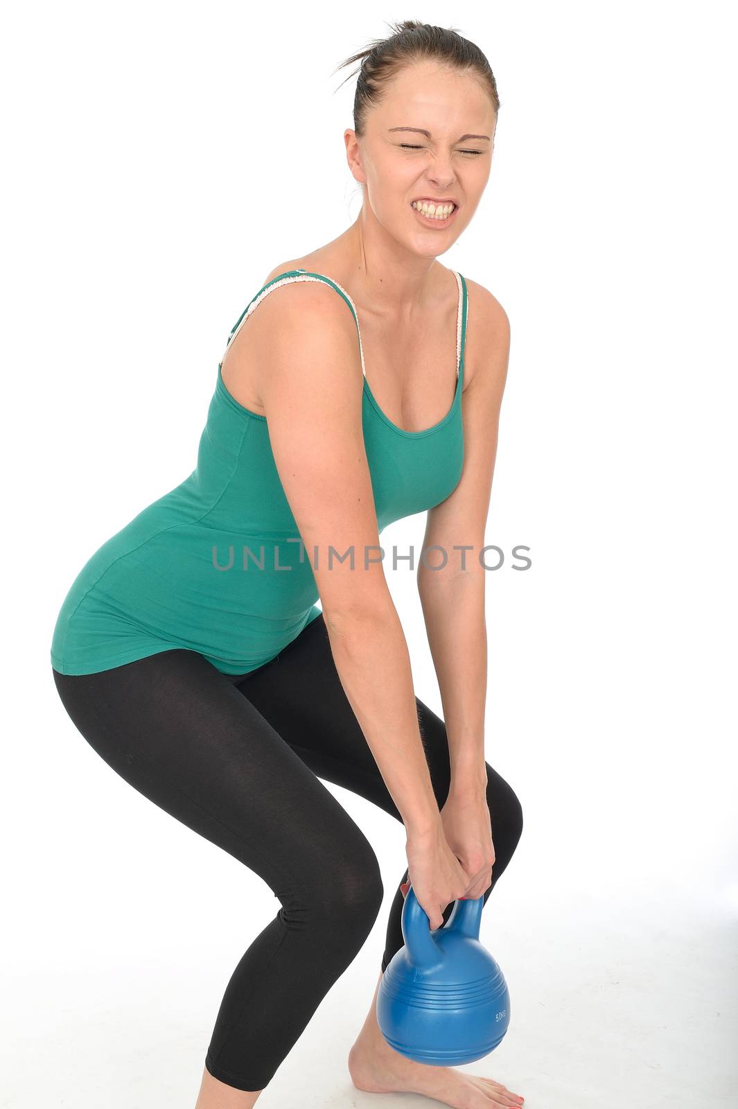 Attractive Healthy Young Woman Working Out Lifting a 5kg Kettle Bell Weight