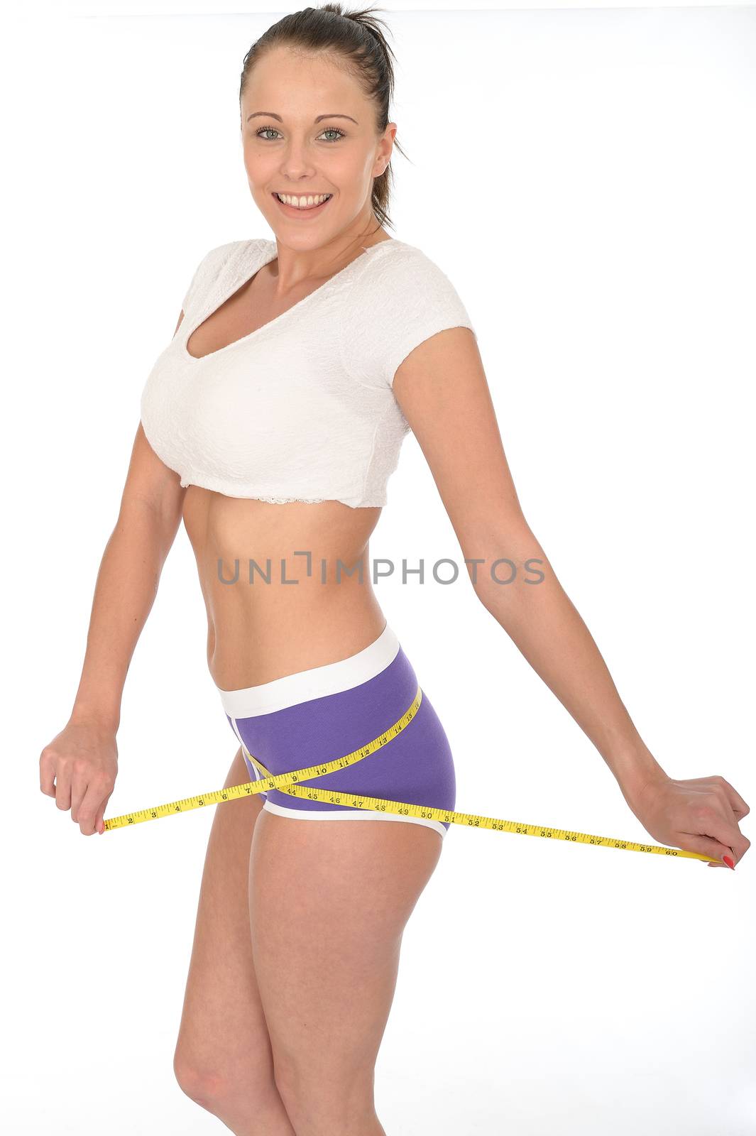 Healthy Young Woman Checking Her Weight Loss With a Tape Measure by Whiteboxmedia