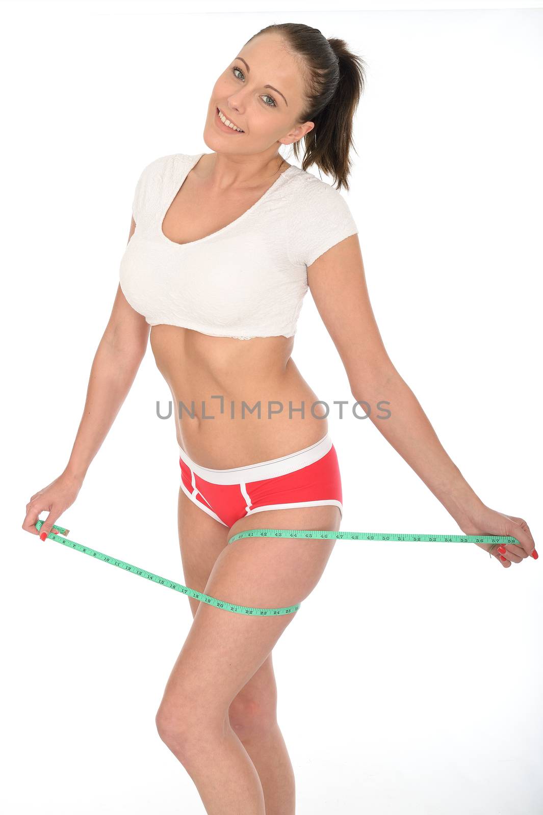 Healthy Fit Young Woman Checking Her Weight Loss With a Tape Measure