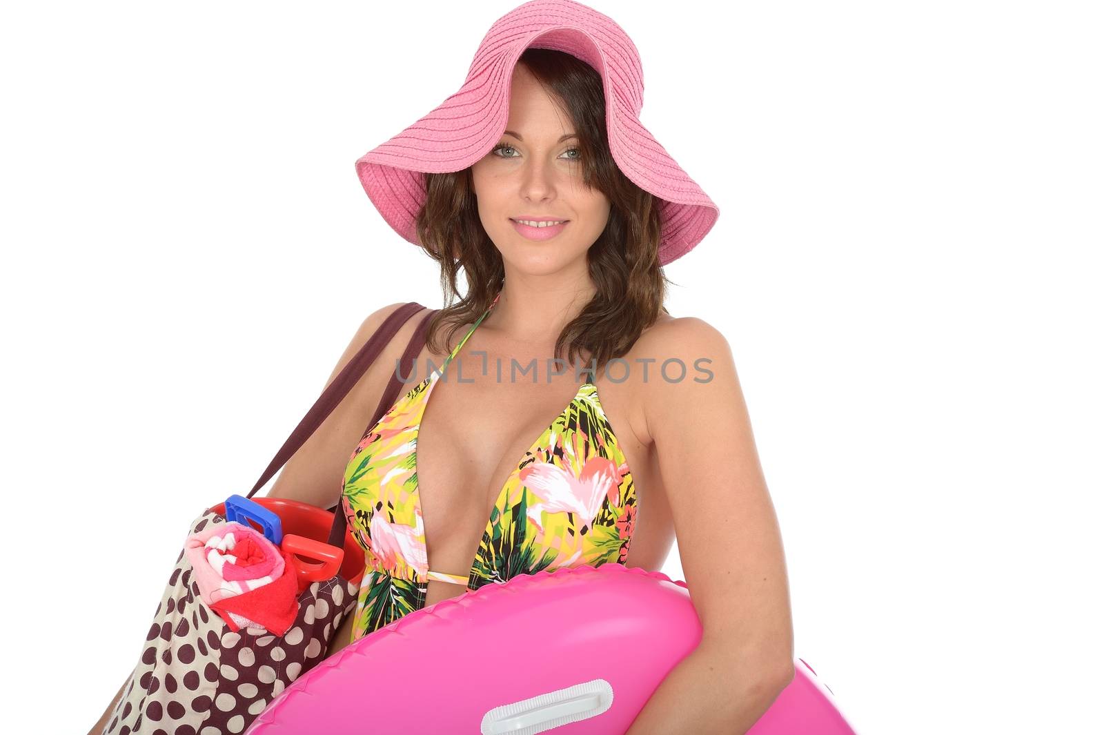 Young Woman Wearing a Swim Suit on Holiday Carrying a  PInk Rubber Ring and Shoulder Bag