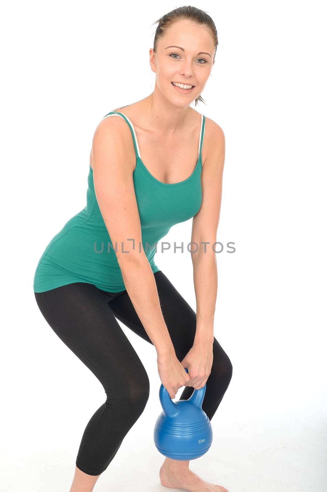 Attractive Healthy Young Woman Working Out Lifting a 5kg Kettle Bell Weight