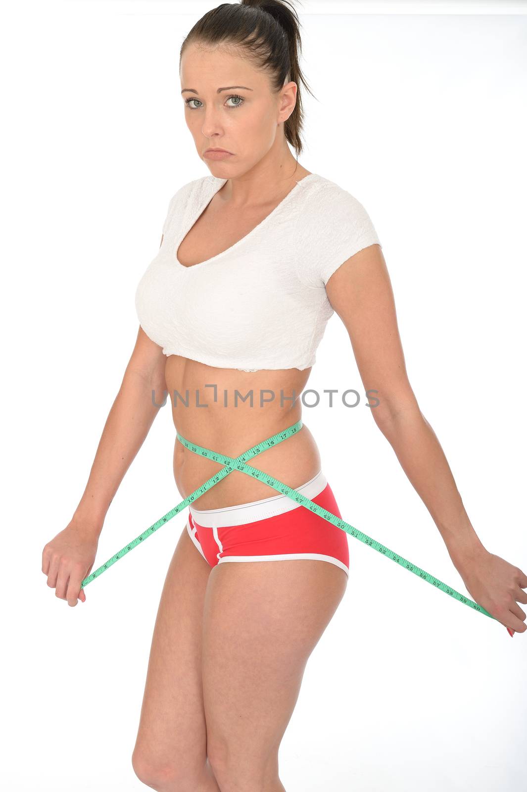 Healthy Young Woman Checking Her Weight Loss With a Tape Measure by Whiteboxmedia