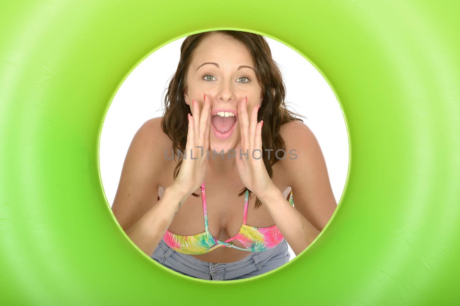 Attractive Young Woman Looking Through a Green Rubber Ring Shouting